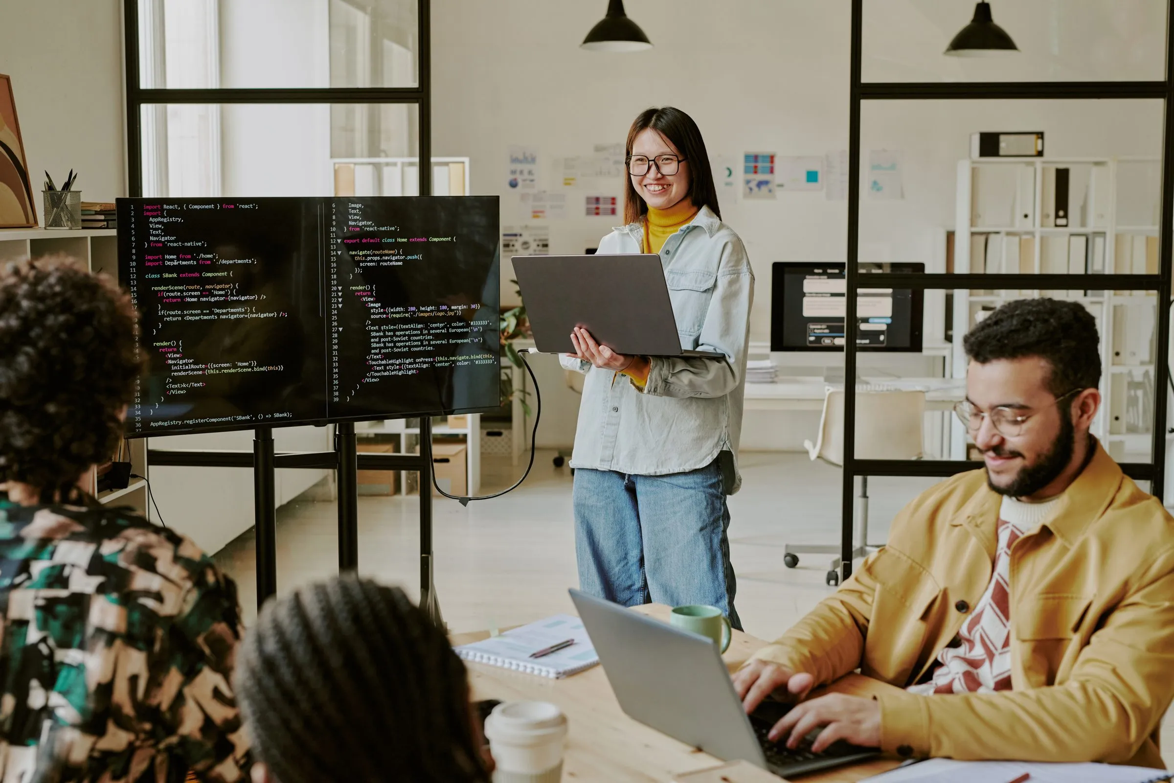 Three colleagues reviewing vendor security evidence together in an open-plan office